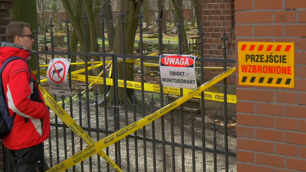 Download Stock Video Man Looking At A Closed Fence With Warning Sign Animated Wallpaper