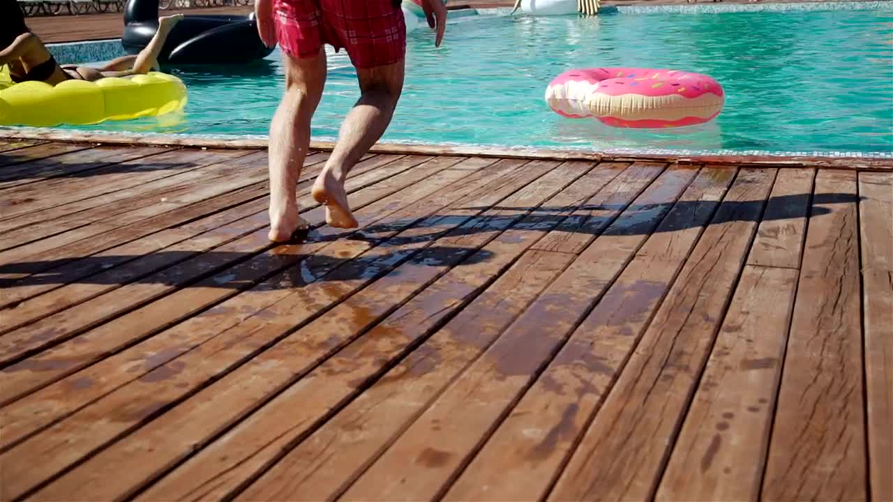 Download Stock Video Man Jumps In Center Of Donut Float In Poo Animated Wallpaper