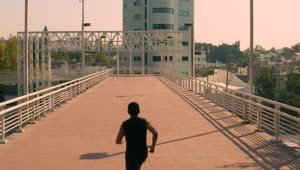 Download Stock Video Man Jogging On A Pedestrian Bridge In The Cit Animated Wallpaper