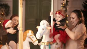 Download Stock Video Mothers With Their Daughters On A Christmas Carousel Live Wallpaper