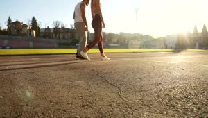 Download Stock Video Motivated Couple Lunge At Start Of Race On Outdoor Track Live Wallpaper
