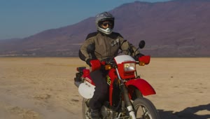 Download Stock Video Motorcyclist In The Arid Desert Live Wallpaper