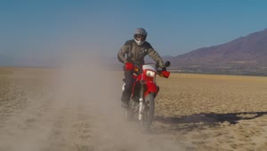Download Stock Video Motorcyclist On A Red Motorcycle In The Desert Live Wallpaper