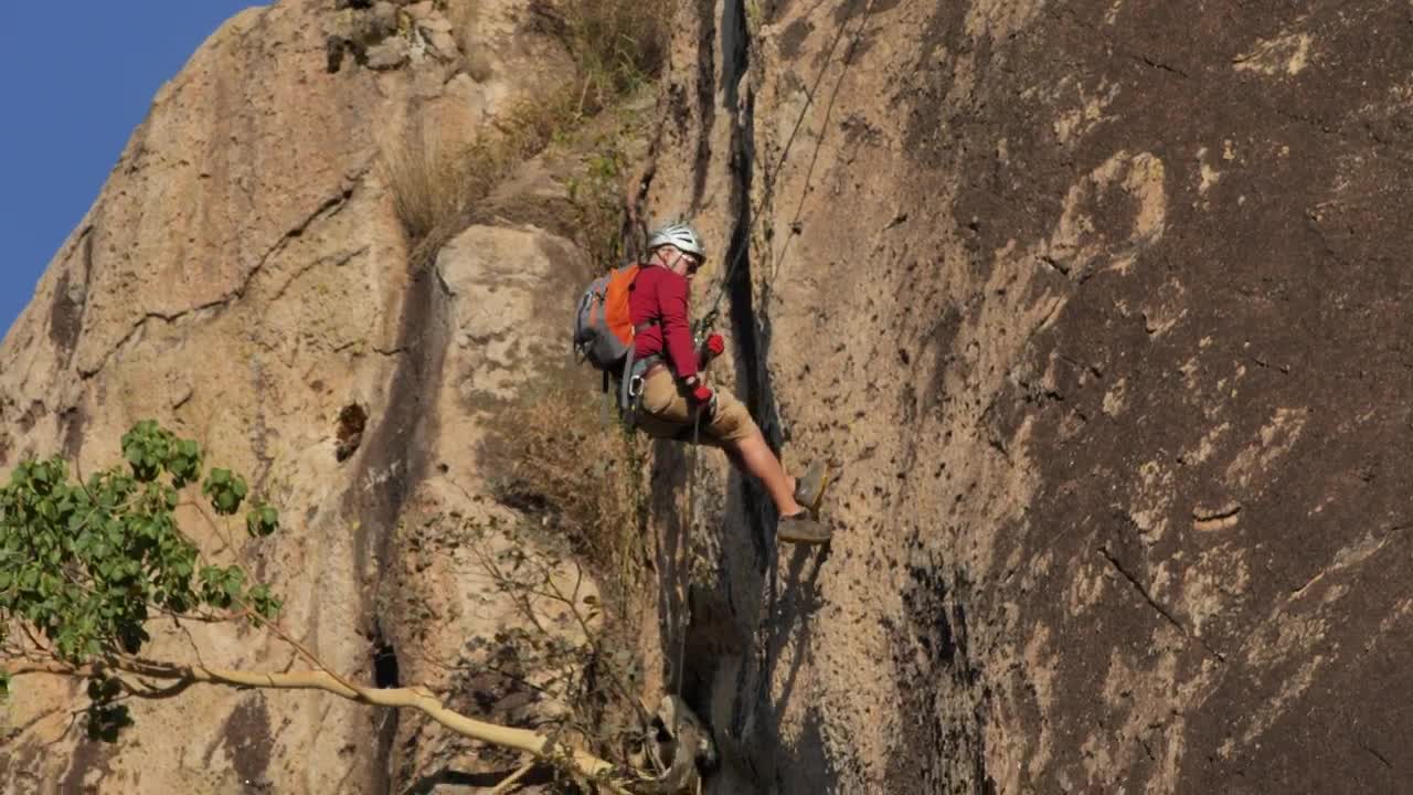 Download Stock Video Mountaineer Descending A Rocky Mountain Live Wallpaper