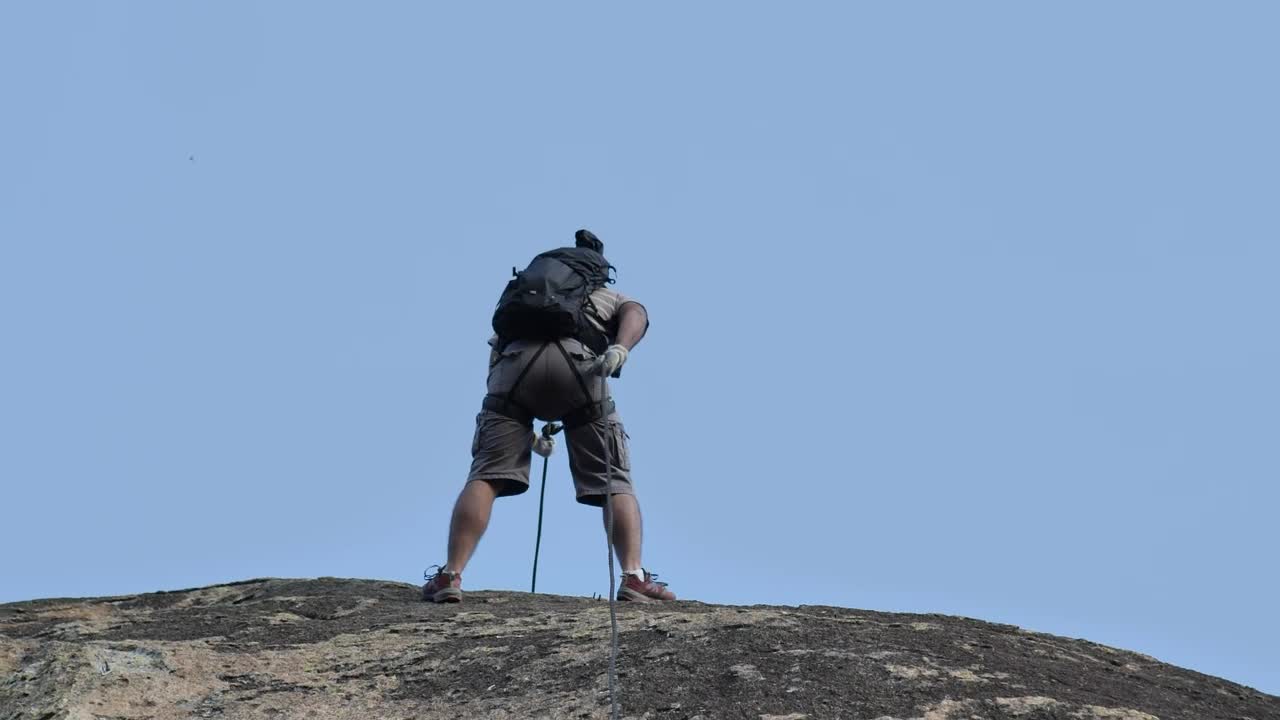 Download Stock Video Mountaineer Descending A Rocky Slope Live Wallpaper