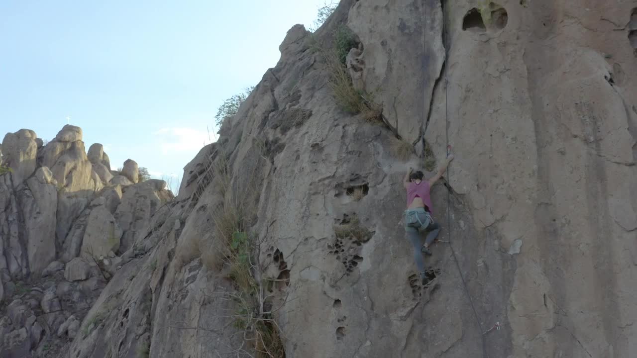 Download Stock Video Mountaineer Girl Climbing A Steep Rocky Mountain Live Wallpaper