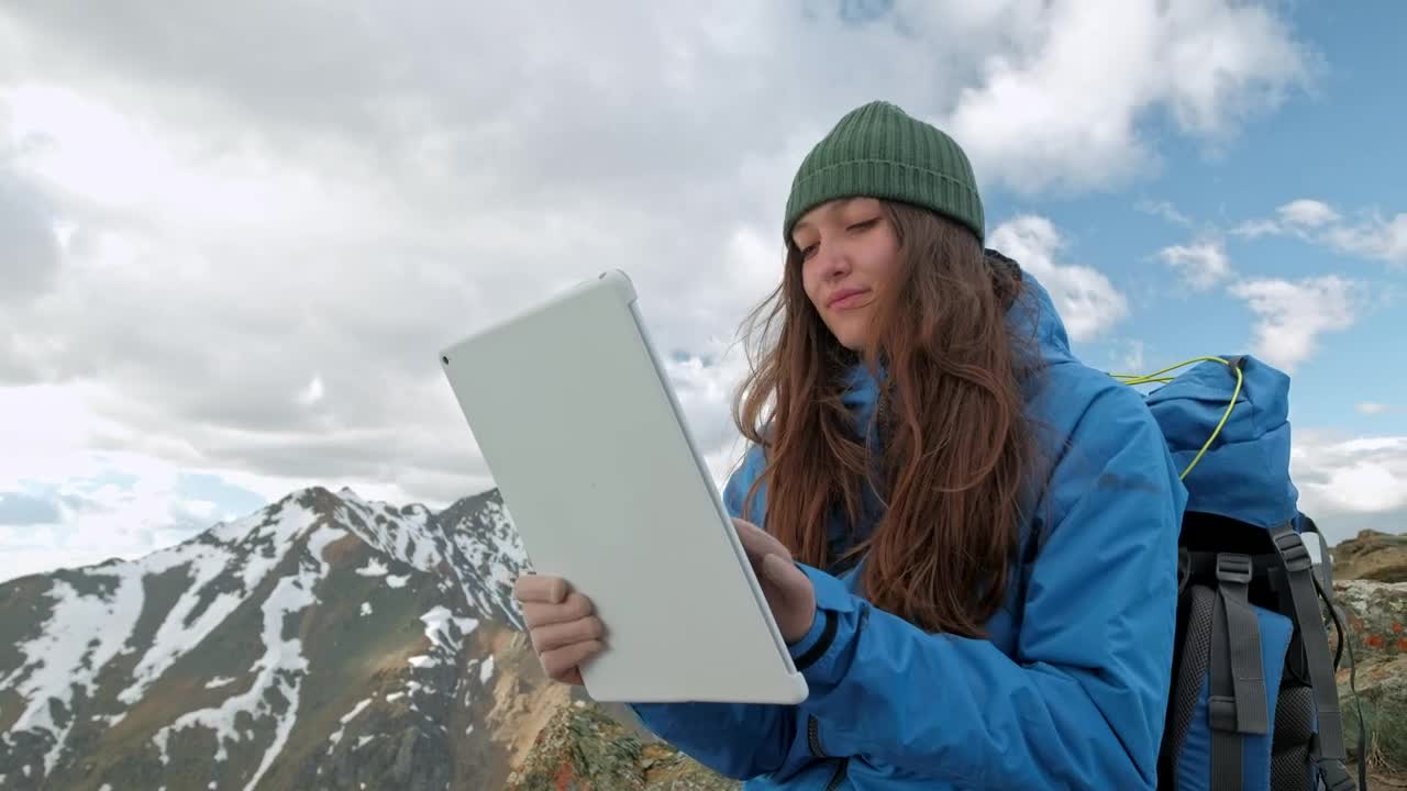 Download Stock Video Mountaineer Using A Tablet On A Mountain Live Wallpaper