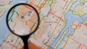 Download Stock Video Observing With A Magnifying Glass On A Map Of Manhattan Live Wallpaper