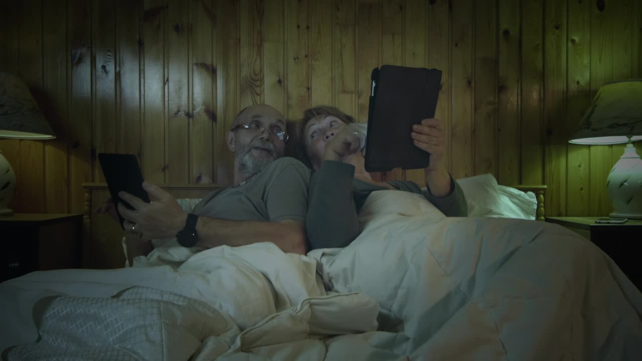 Download Stock Video Old Couple With Tablets In The Bedroom Live Wallpaper