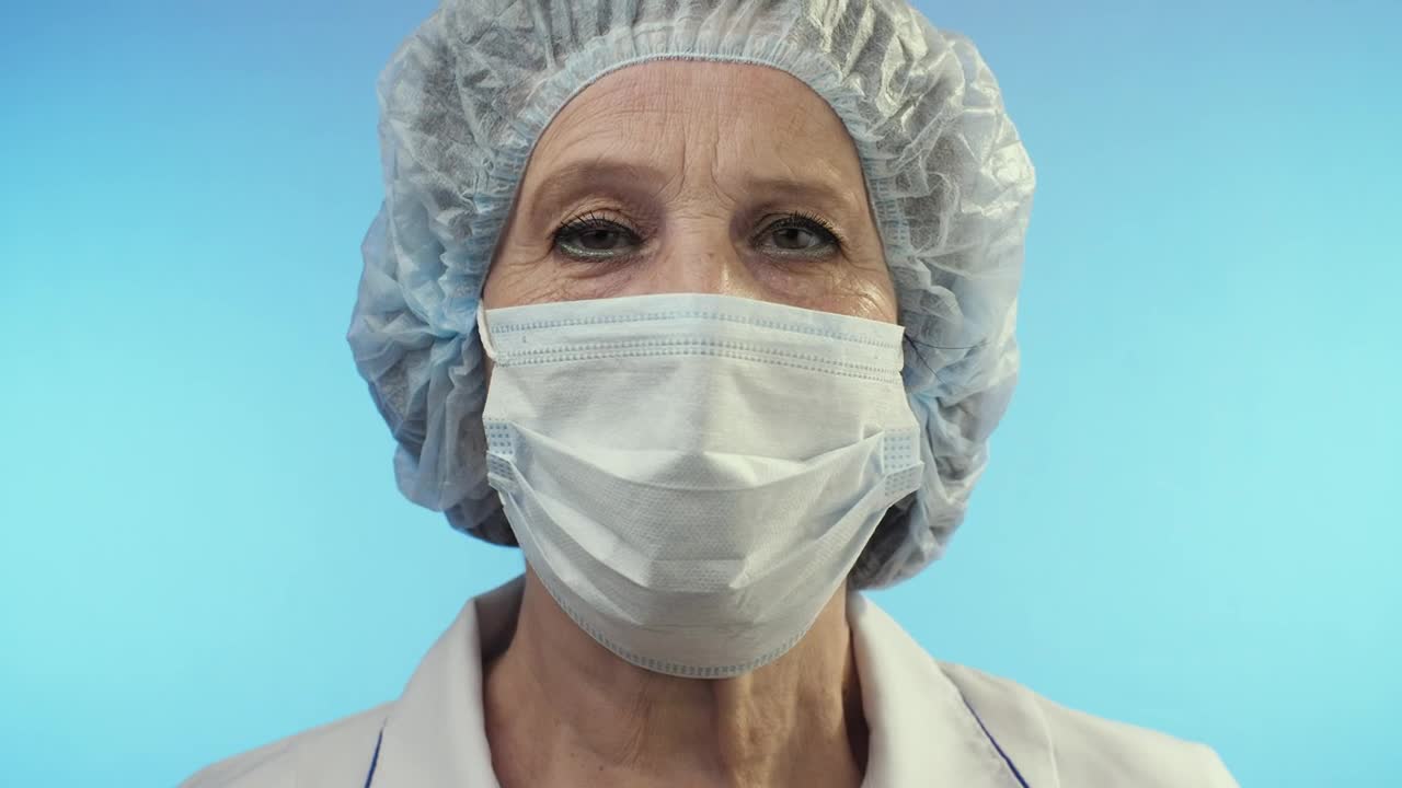 Download Stock Video Old Female Doctor Wearing Face Shield From Surgery Live Wallpaper