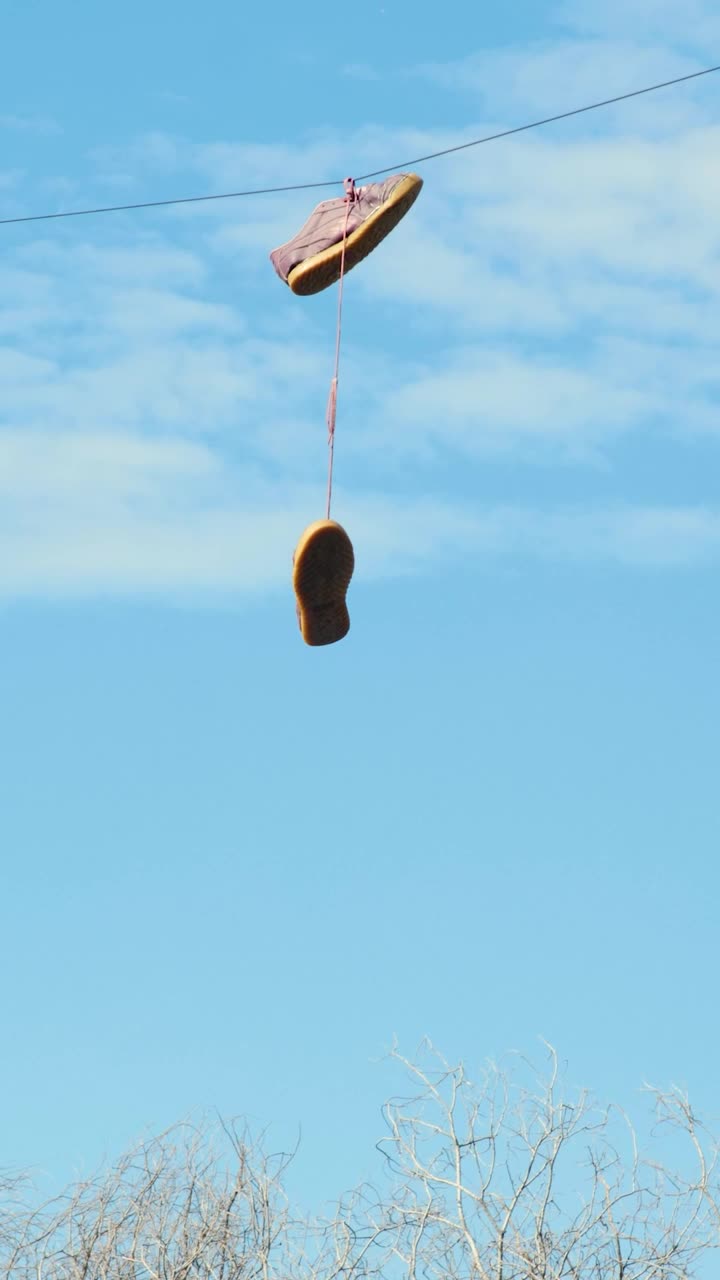 Download Stock Video Old Shoes Hanging On An Electric Wire Live Wallpaper