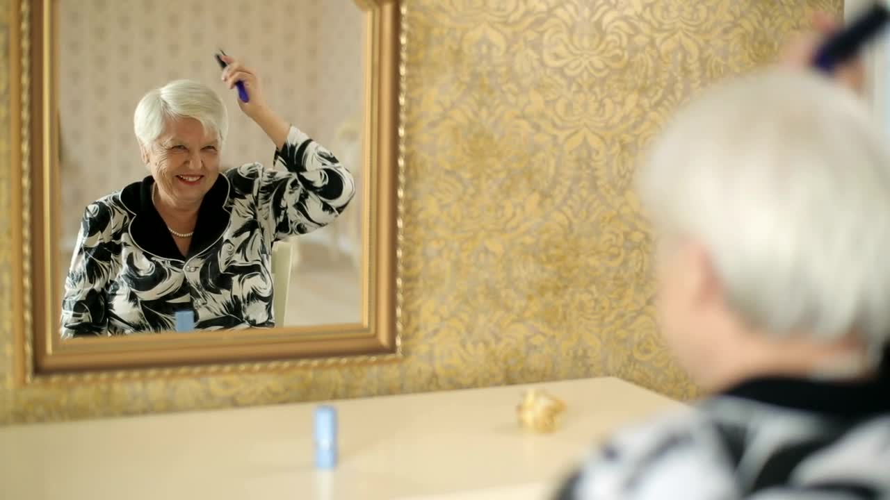 Download Stock Video Old Woman Combing Her Gray Hair Live Wallpaper