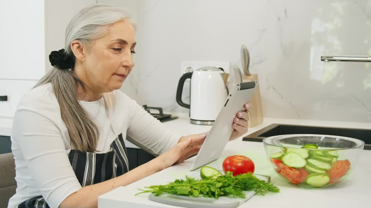 Download Stock Video Old Woman Searching For Healthy Recipes Live Wallpaper