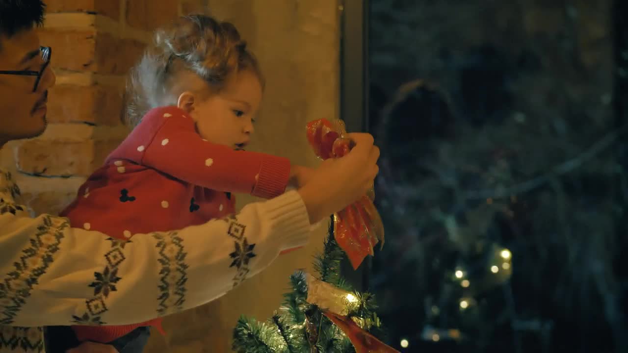 Download Stock Video Parents And Daughter Putting A Bow On The Top Of Live Wallpaper