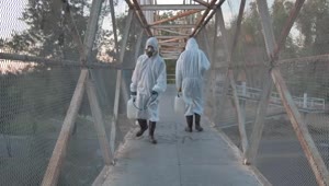 Download Stock Video People With Masks Sanitizing A Pedestrian Bridge Live Wallpaper
