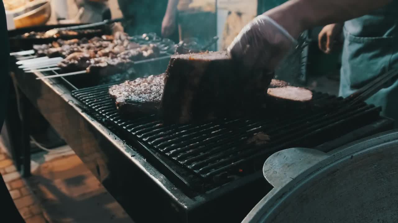 Download Stock Video Person Cooking Cuts Of Meat On The Grill Live Wallpaper