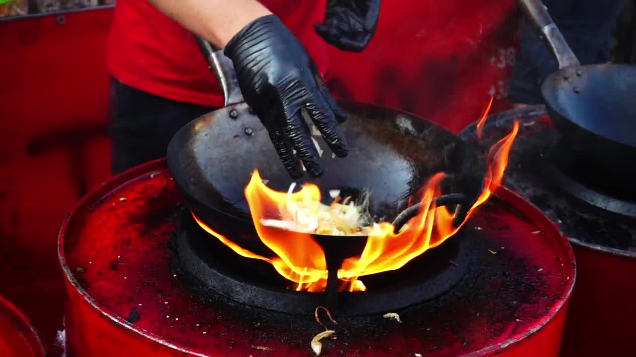 Download Stock Video Person Cooking In A Wok Pan With High Flame Live Wallpaper