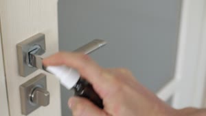 Download Stock Video Person Disinfecting A Door With Spray Live Wallpaper