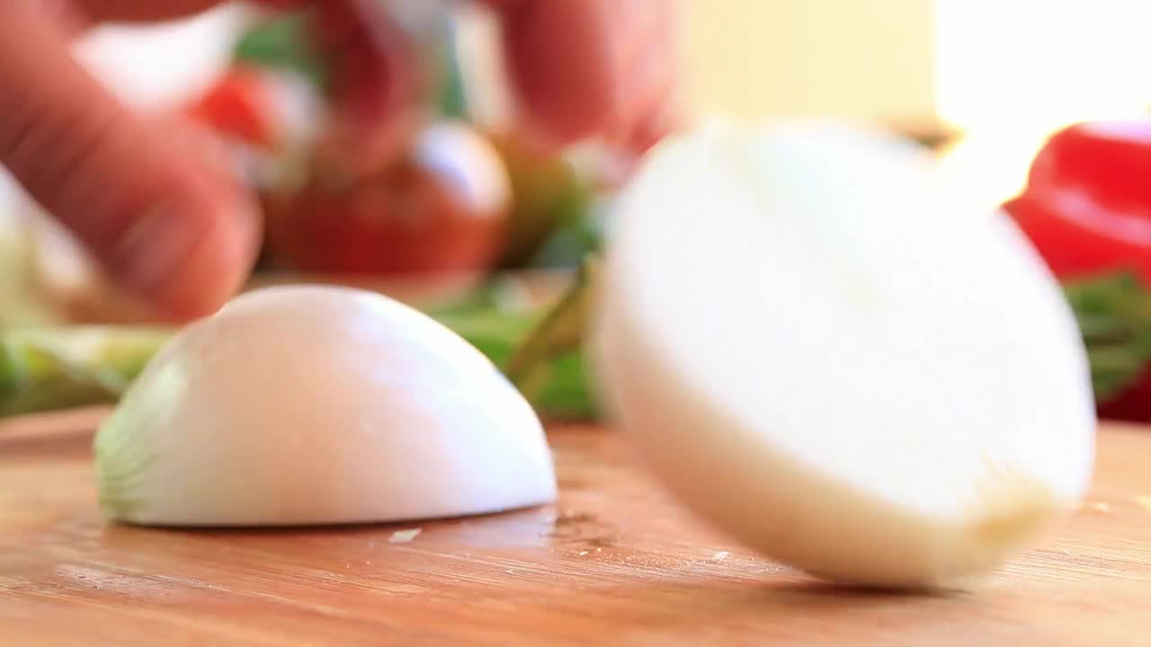 Download Video Stock Person Slicing Onion On A Board Live Wallpaper Free