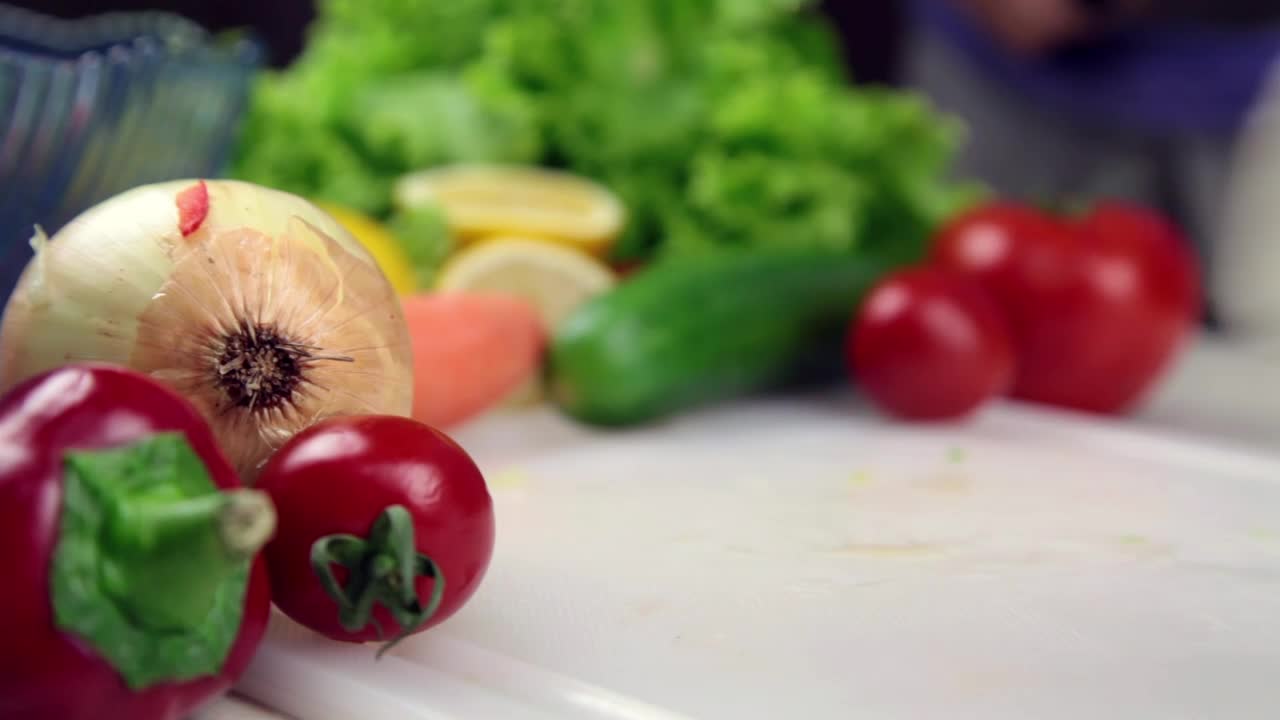 Download Video Stock Person Slicing Cheese At A Table With Vegetables Live Wallpaper Free