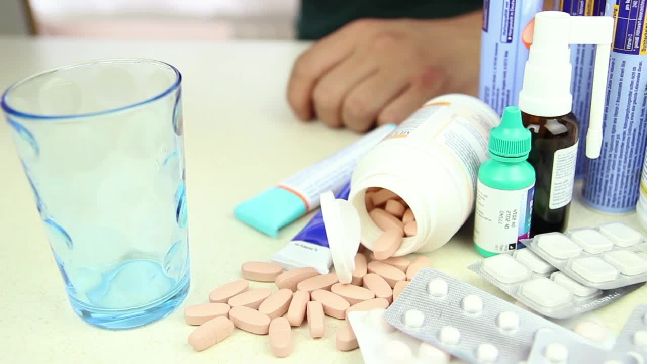 Download Video Stock Person Taking A Pill Among Other Drugs Live Wallpaper Free