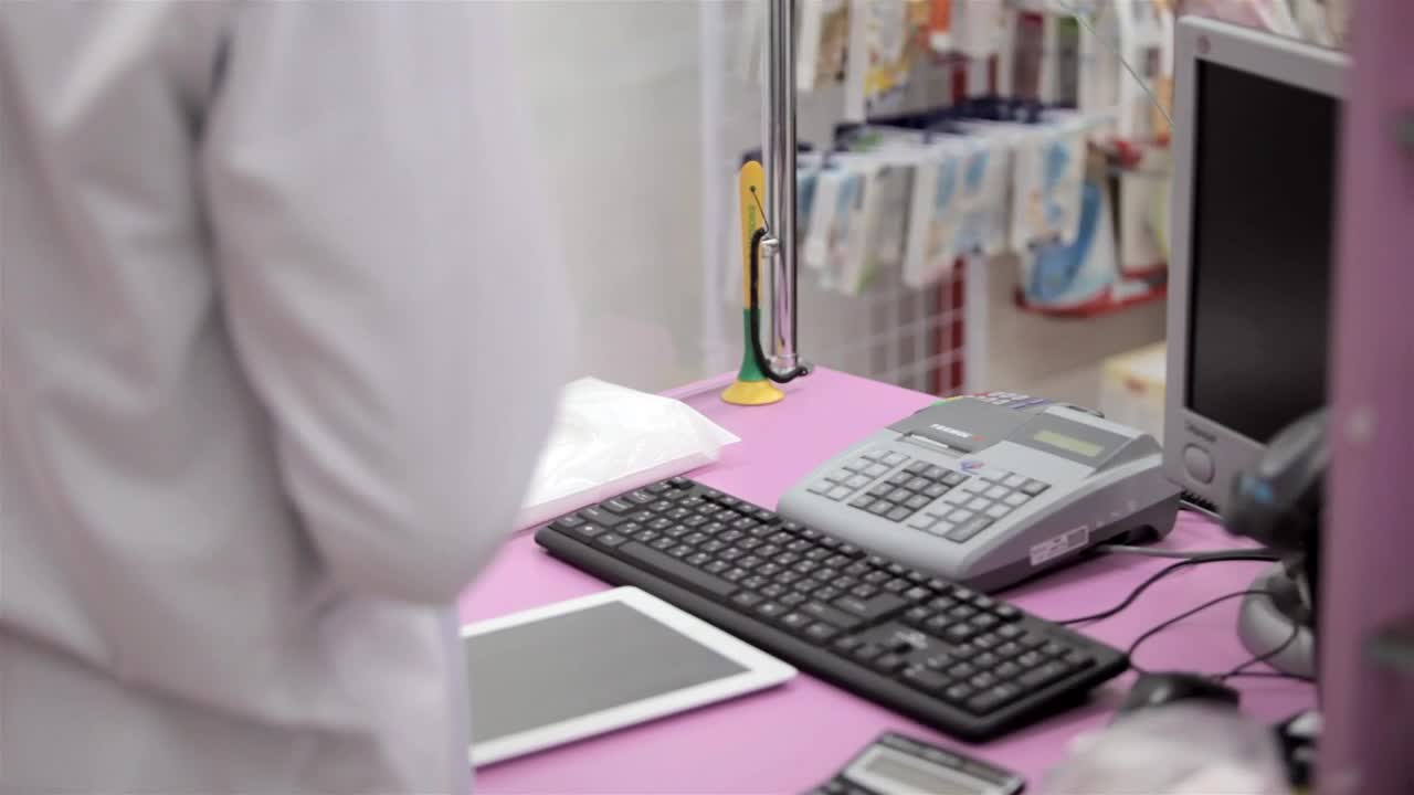 Download Video Stock Pharmacy Worker Accepts Payment At Checkout Live Wallpaper Free