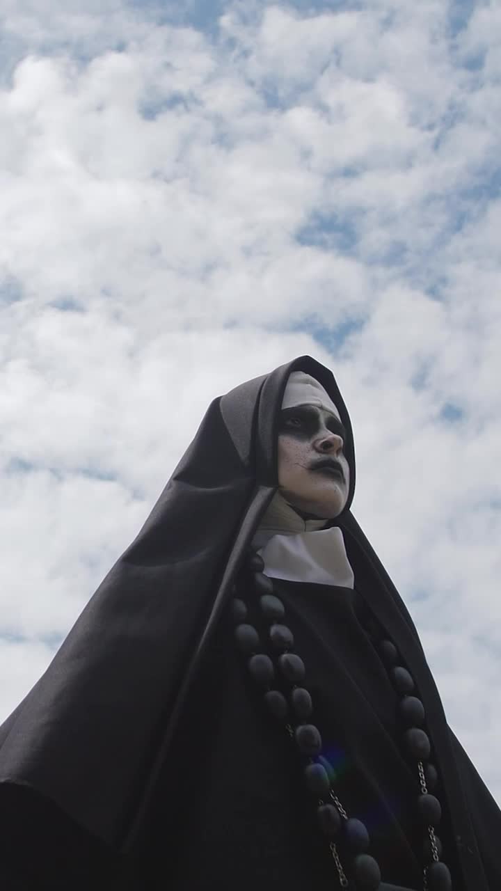 Download Video Stock Portrait Of A Devilish Nun Smiling Live Wallpaper Free