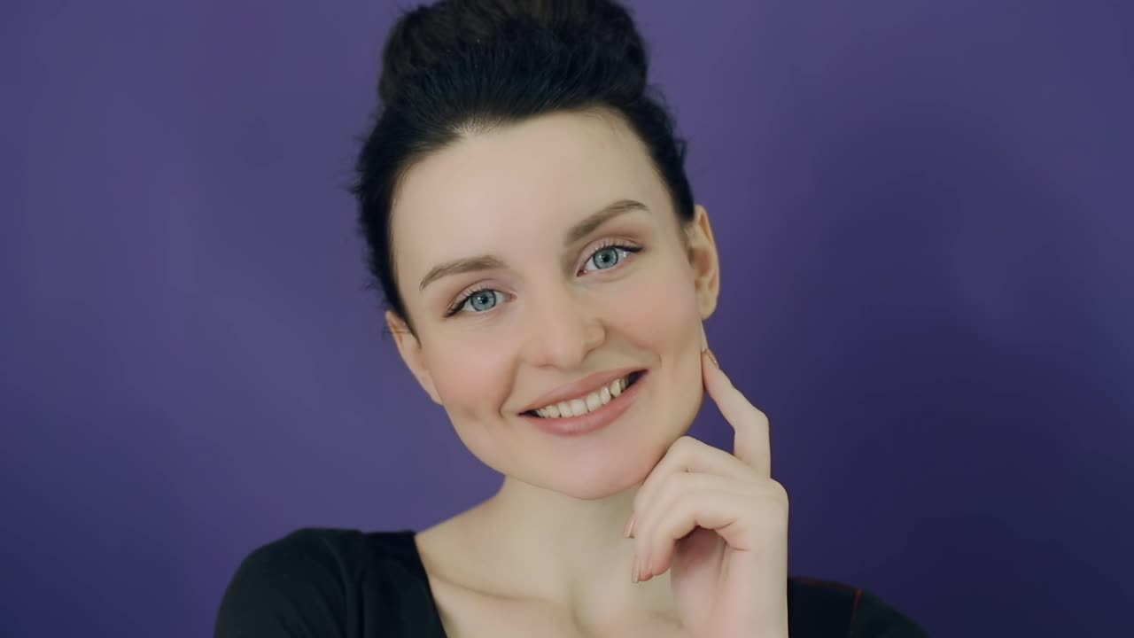 Download Video Stock Portrait Of A Smiling Woman With Purple Background Live Wallpaper Free