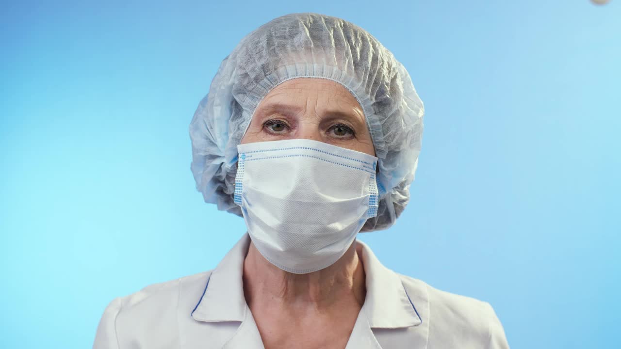 Download Video Stock Portrait Of An Adult Female Doctor On Blue Live Wallpaper Free