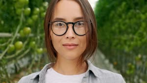 Download Video Stock Portrait Of An Agricultural Woman With Glasses In A Greenhouse Live Wallpaper Free