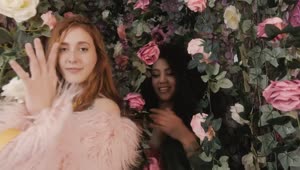 Download Video Stock Portrait Of Two Funny Girls Among Many Flowers Live Wallpaper Free