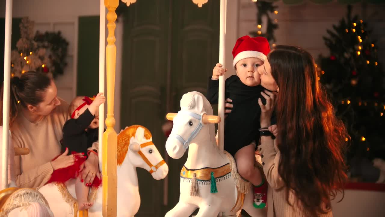 Download Video Stock Portrait Of Two Moms With Their Babies At A Carousel Live Wallpaper Free