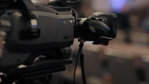 Download Video Stock Professional Video Camera On A Tripod Recording A Talk Live Wallpaper Free
