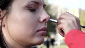 Download Video Stock Putting Makeup On A Woman On The Street Live Wallpaper Free