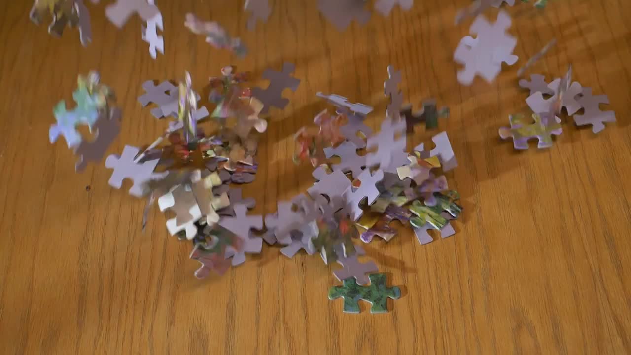 Download Video Stock Puzzle Pieces Falling On A Table Live Wallpaper Free