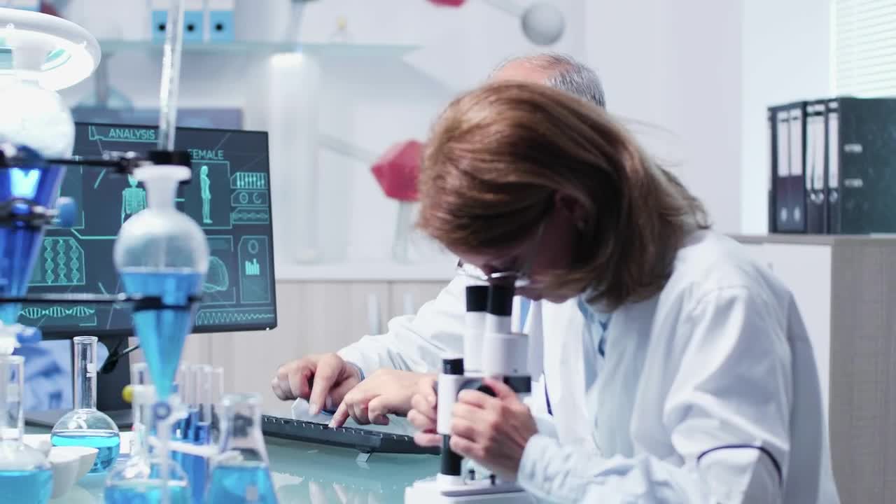 Download Free Stock Video Research Scientists Collaborate In Modern Lab Live Wallpaper