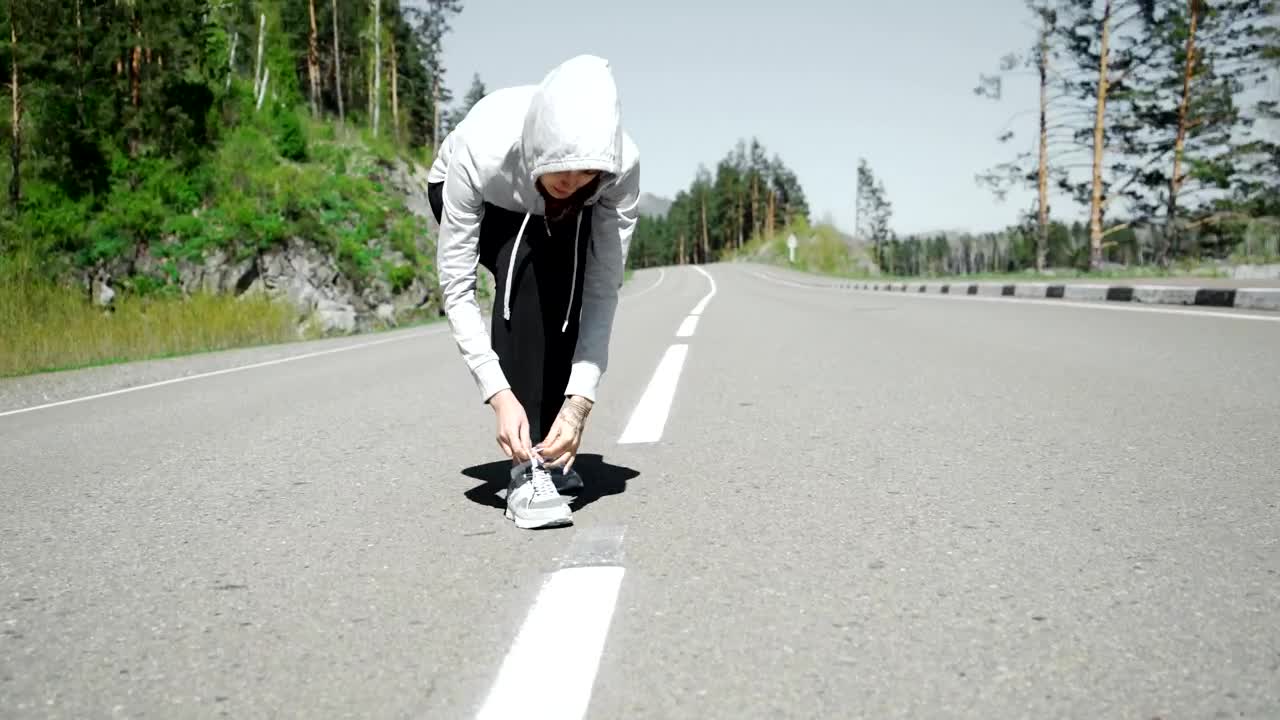 Download Free Stock Video Runner Ties Laces Before Starting Jog On Mountain Road Live Wallpaper