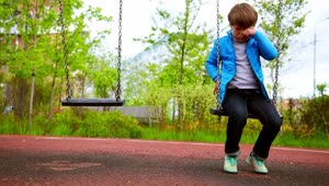 Download Free Stock Video Sad Lonely Boy Sitting On The Swings At The Playground Live Wallpaper