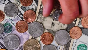 Download Free Stock Video Scene Covered In Bills And Coins As A Person Takes Live Wallpaper