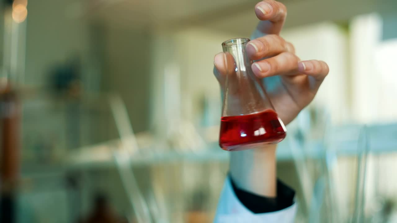 Download Free Stock Video Scientist Shaking A Conical Flask In The Laboratory Live Wallpaper