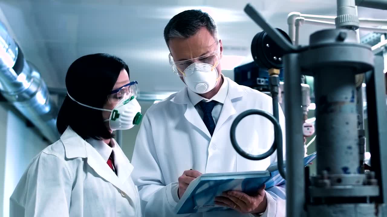 Download Free Stock Video Scientist Taking Notes From Lab Equipment Live Wallpaper