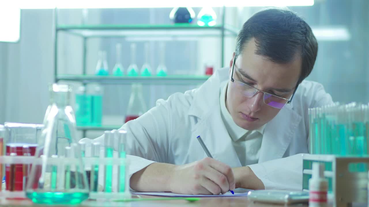 Download Free Stock Video Scientist Writing In The Lab Live Wallpaper