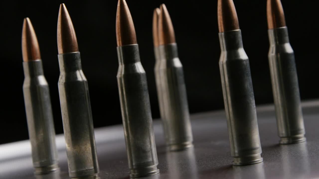 Download Free Stock Video Several Bullets Rotating On A Metal Plate Live Wallpaper