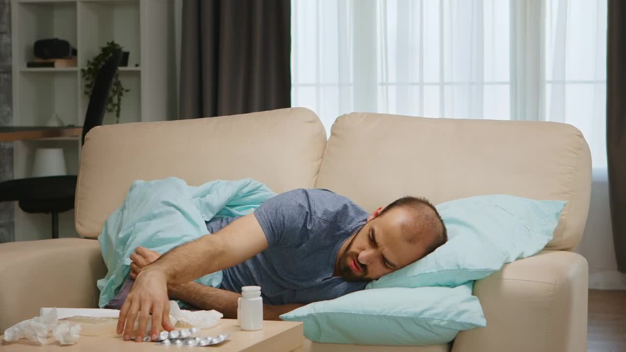 Download Free Stock Video Sick Man Lays On Sofa And Looks At Medication Live Wallpaper