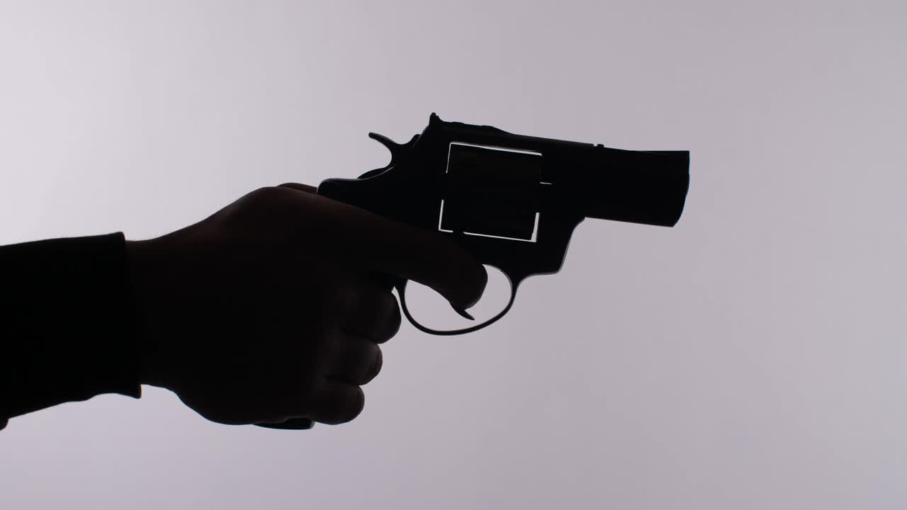 Download Free Stock Video Silhouette Of A Hand Firing A Revolver Live Wallpaper