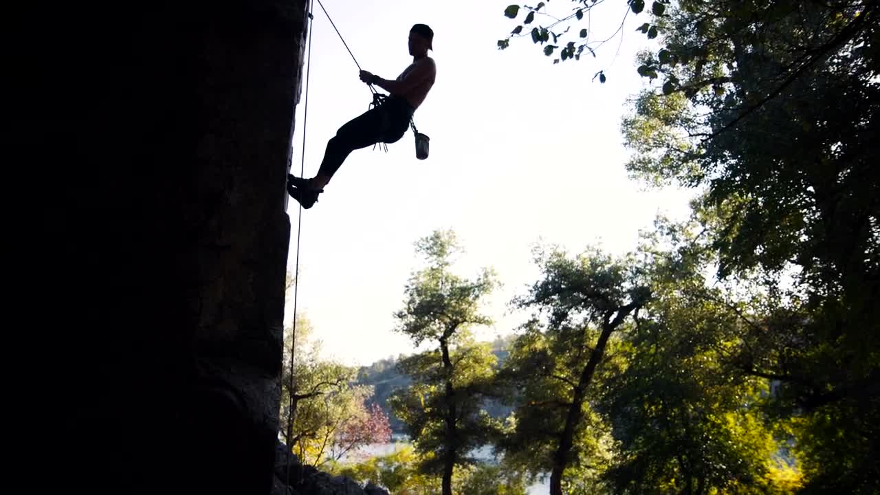 Download Free Stock Video Silhouette Of A Man Doing An Abseil Live Wallpaper