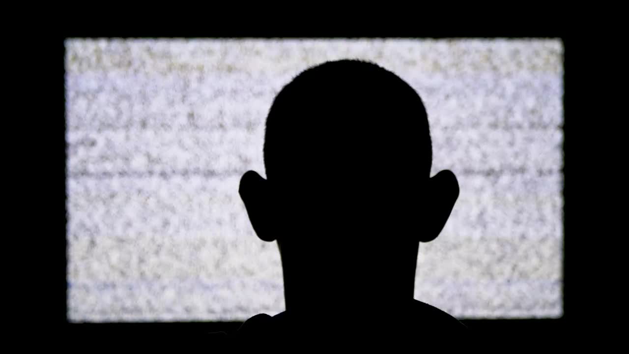 Download Free Stock Video Silhouette Of A Man In Front Of A Tv With Live Wallpaper