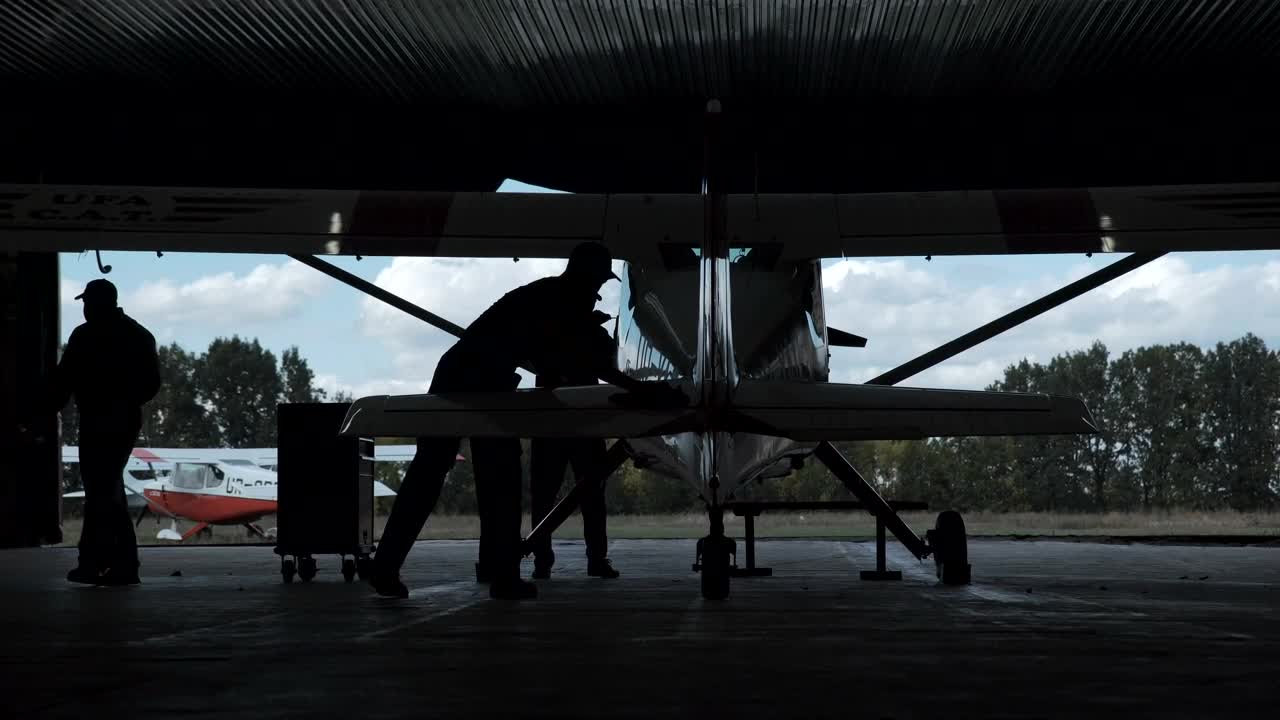 Download Free Stock Video Silhouette Of A Man Polishing A Biplane Live Wallpaper