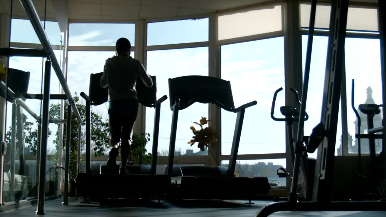 Download Free Stock Video Silhouette Of A Woman Running In The Treadmill Live Wallpaper