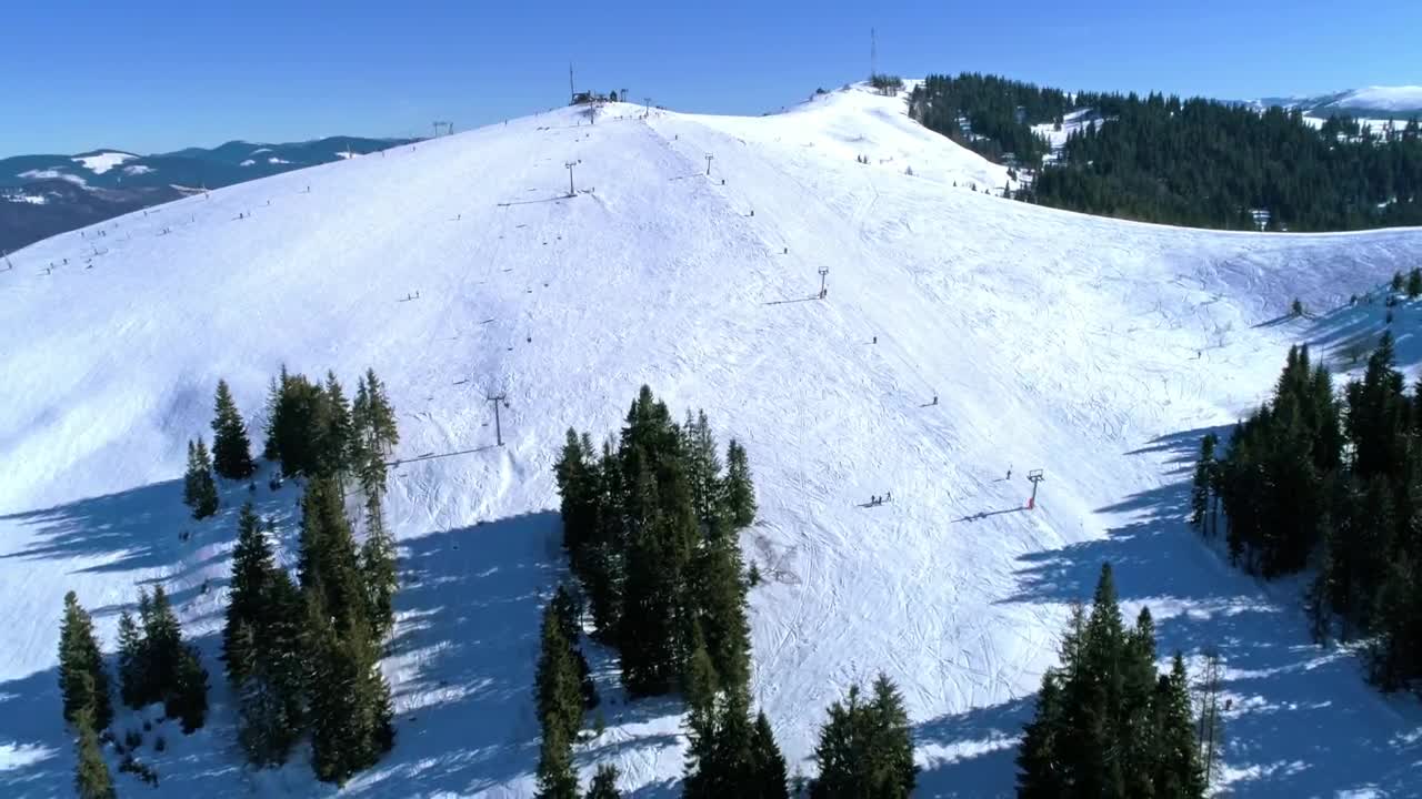 Download Free Video Stock Ski Area On A Snowy Mountain With Few Trees Live Wallpaper